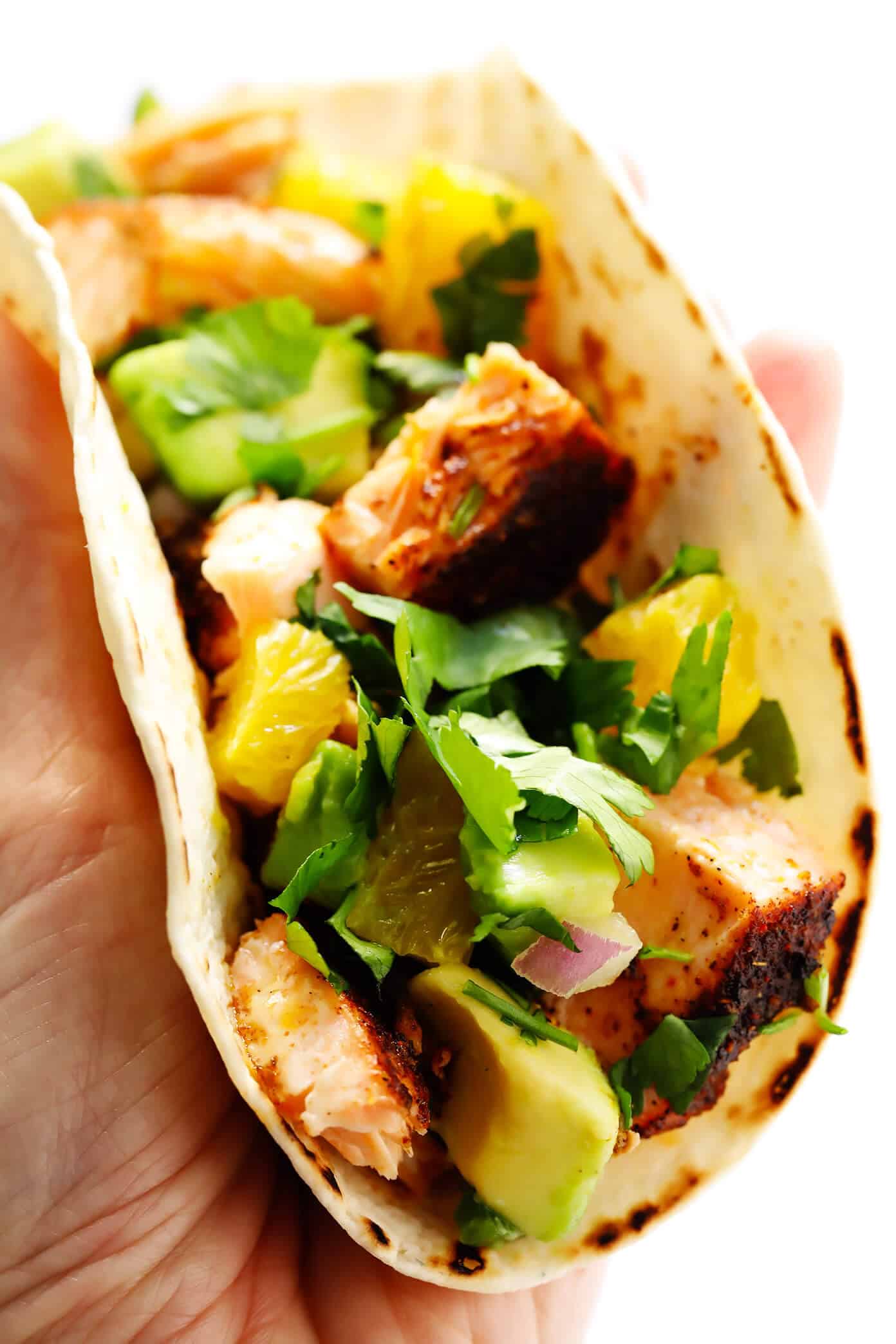 These Super-Simple Salmon Tacos are topped with a juicy fresh orange avocado salsa, seasoned with a zesty chili rub, and can be on the table in just 30 minutes. A delicious, quick, easy and healthy dinner recipe that everyone will love! | gimmesomeoven.com #salmon #tacos #mexican #fish #glutenfree #salsa #dinner #healthy Salmon Tacos with Avocado Orange Salsa