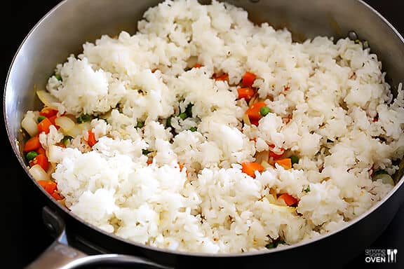 The BEST homemade fried rice recipe!! It only takes 15 minutes to make, it's easy to customize with your favorite add-ins (like chicken, pork, beef, shrimp, tofu, and/or vegetables), and it is SO flavorful and delicious! Way better than any Chinese takeout I've ever tried. ;) | gimmesomeoven.com #rice #friedrice #chinese #dinner #takeout #vegetarian #asian #easy How To Make Fried Rice | Be sure to start with cold rice