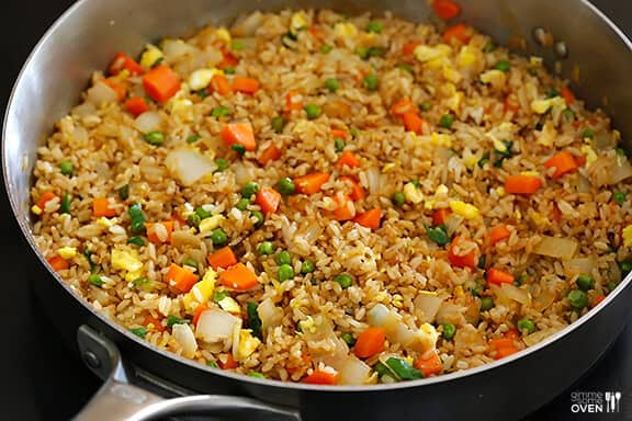 The BEST homemade fried rice recipe!! It only takes 15 minutes to make, it's easy to customize with your favorite add-ins (like chicken, pork, beef, shrimp, tofu, and/or vegetables), and it is SO flavorful and delicious! Way better than any Chinese takeout I've ever tried. ;) | gimmesomeoven.com #rice #friedrice #chinese #dinner #takeout #vegetarian #asian #easy How To Make Stir Fried Rice