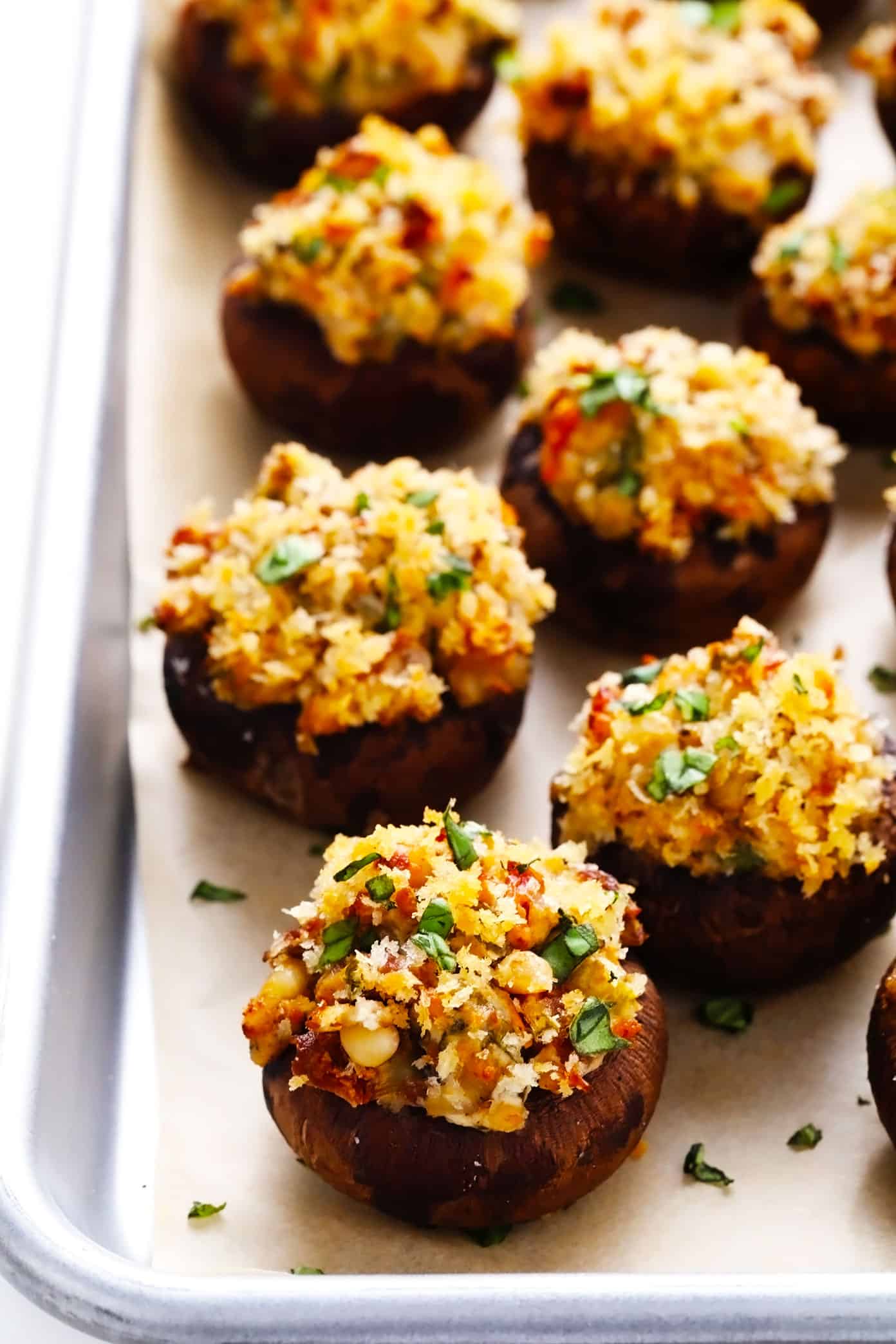 This easy stuffed mushrooms recipe is made with a garlicky goat cheese, sun-dried tomato, pine nut and basil filling and topped with crispy toasted breadcrumbs. The perfect vegetarian appetizer that's easy to make ahead of time (up to 1 day in advance) and always a crowd fave! | gimmesomeoven.com Stuffed Mushrooms