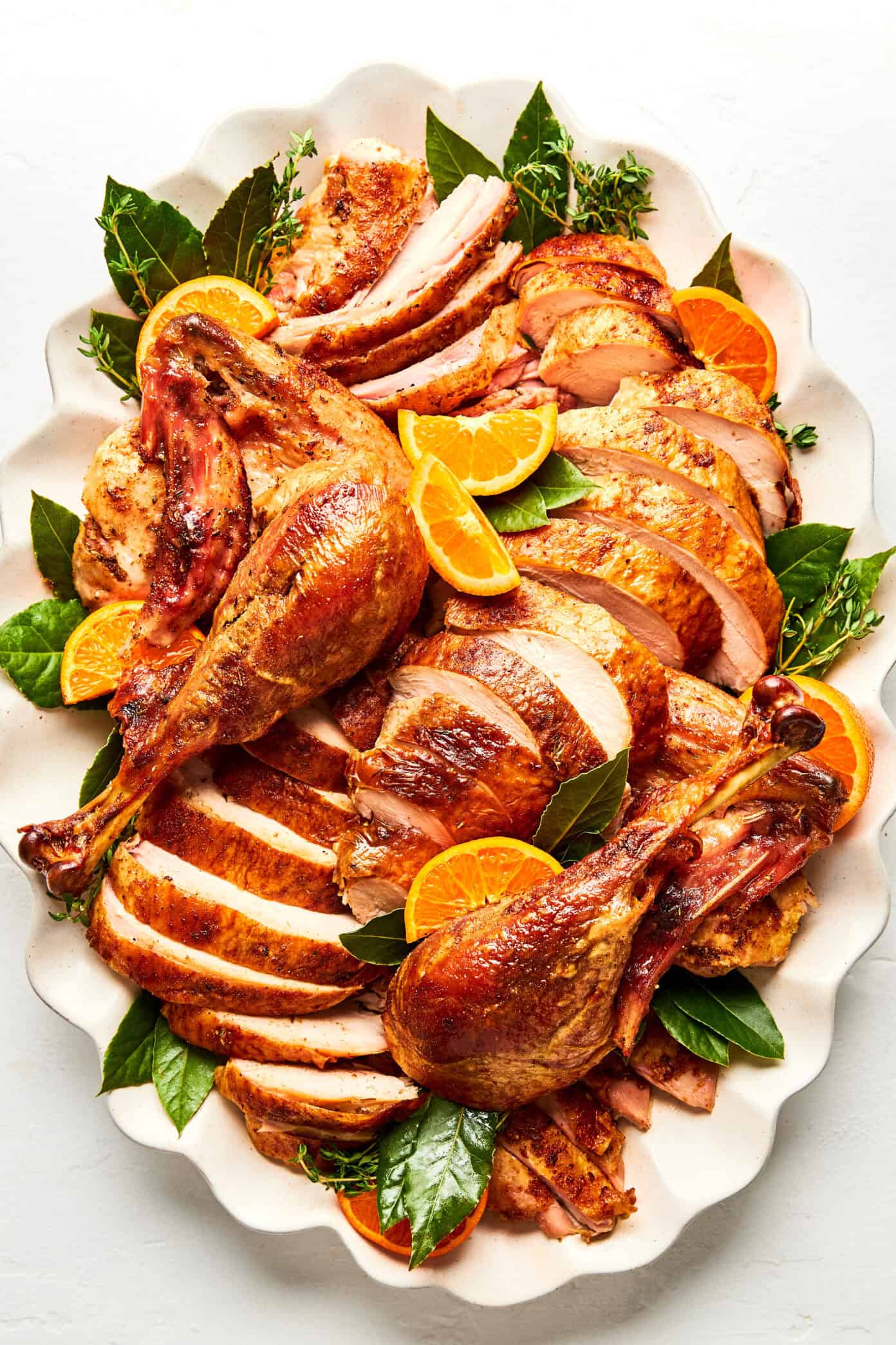 carved roast turkey on platter with oranges