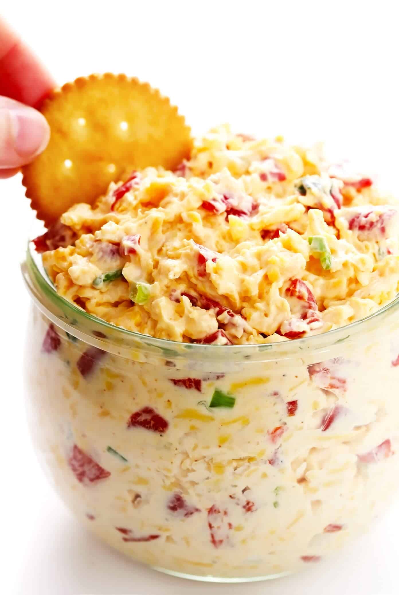 This 10-minute homemade pimento cheese recipe is made with sharp cheddar, tangy cream cheese and mayo, roasted red peppers, fresh green onions, and a zesty blend of seasonings. Serve it as a appetizer dip or spread on sandwiches, burgers, veggies, or whatever sounds good. | gimmesomeoven.com #pimento #pepper #cheese #dip #spread #glutenfree #southern #sandwich Pimento Cheese
