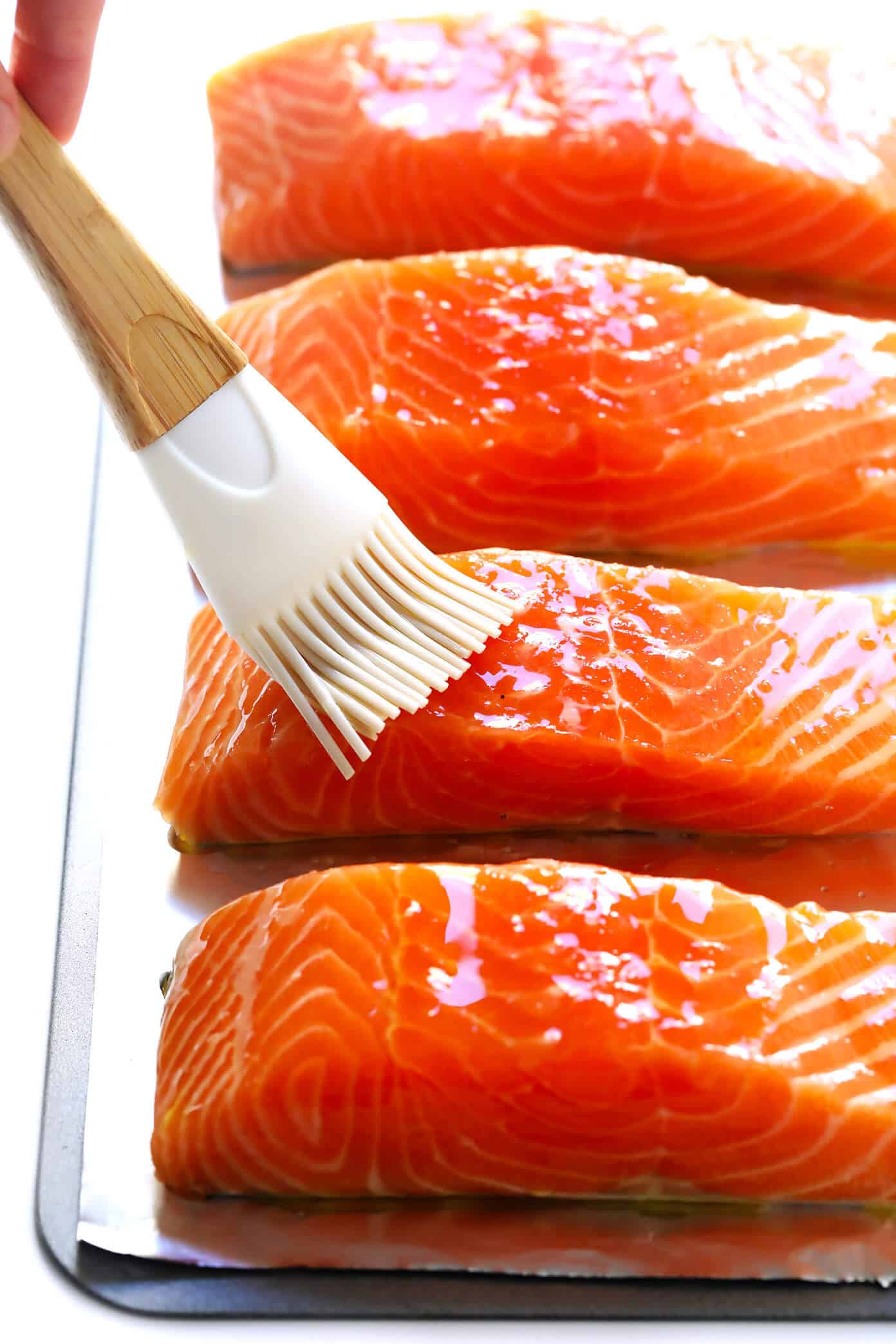 The BEST Oven Baked Salmon recipe! Easy to make in less than 15 minutes, perfectly cooked, and easy to season with lemon, herbs, or whatever your favorite seasonings or sauces may be. It's the perfect simple and healthy dinner recipe. | Gimme Some Oven #salmon #healthy #baked #fish #glutenfree #dinner #recipe Baked Salmon Recipe