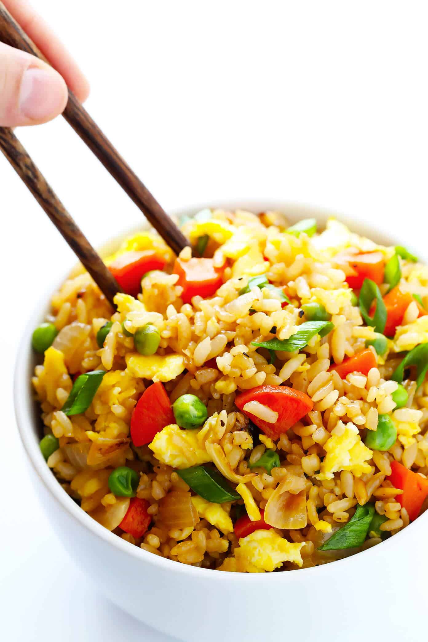The BEST homemade fried rice recipe!! It only takes 15 minutes to make, it's easy to customize with your favorite add-ins (like chicken, pork, beef, shrimp, tofu, and/or vegetables), and it is SO flavorful and delicious! Way better than any Chinese takeout I've ever tried. ;) | gimmesomeoven.com #rice #friedrice #chinese #dinner #takeout #vegetarian #asian #easy The BEST Fried Rice Recipe | Feel free to add chicken, beef, pork, shrimp or extra vegetables