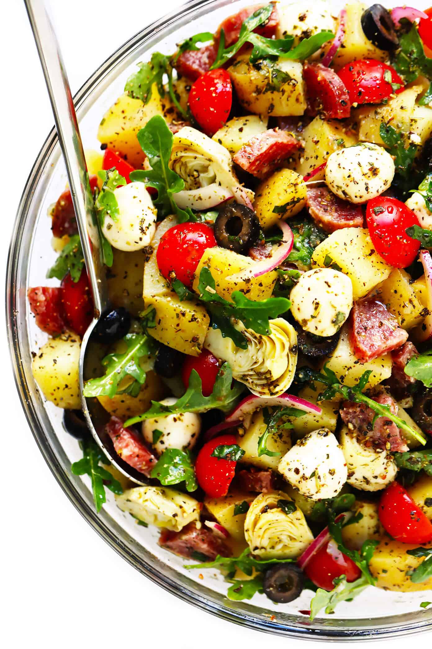 This Italian Potato Salad recipe is made with arugula, mozzarella, salami, tomato, artichokes, olives, and a zesty (and easy!) Italian vinaigrette. And it's SO flavorful and hearty and delicious! It's the perfect make-ahead side dish for picnics, potlucks and more. | gimmesomeoven.com #potatosalad #italian #salad #sidedish #makeahead Italian Potato Salad