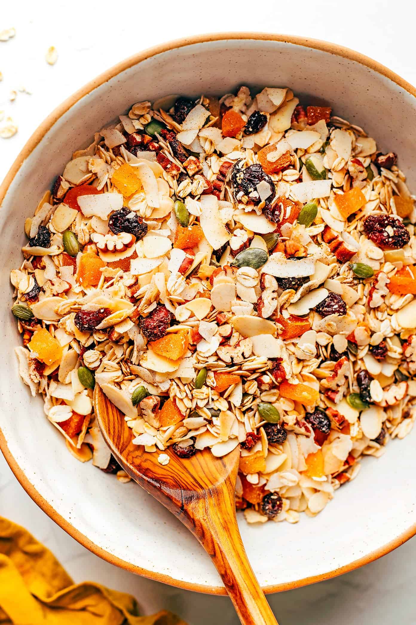 This delicious homemade muesli recipe is easy to make and customize with your favorite blend of oats, nuts, seeds, dried fruit, coconut (optional) and spices. Serve with hot or cold milk, prep "overnight oats"-style, layer as a parfait with Greek yogurt, or however you love best. Always such a great healthy and easy breakfast! | gimmesomeoven.com Muesli