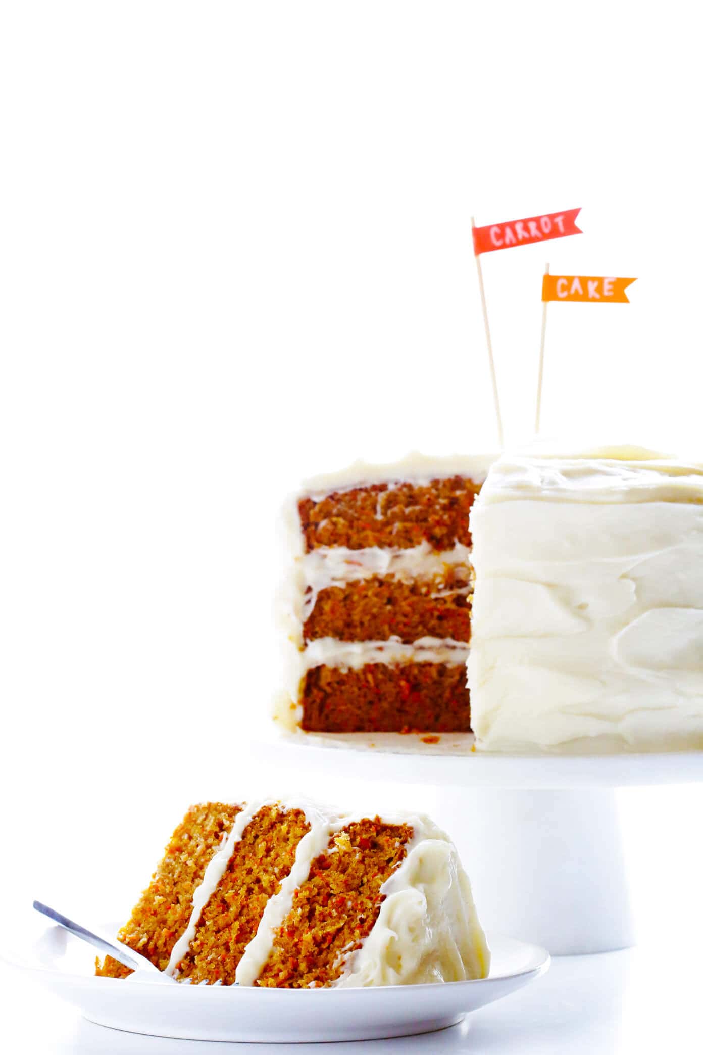 The BEST Carrot Cake Recipe! It's made with an easy homemade carrot cake (no mixer required) and the most heavenly cream cheese frosting. | gimmesomeoven.com #carrot #cake #dessert #easter #creamcheese #frosting #spring #vegetarian Homemade Carrot Cake Recipe